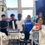 Sylvia Bryson, teacher of dental assisting and a registered dental hygienist, shows off a model of a mouth while leading a group of students on a tour of Central High School’s Dental Academy.