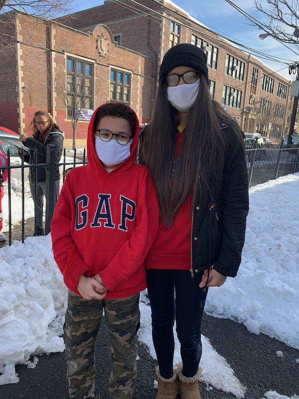 Eight Grade student Hilary Alberto joined by her younger brother Fransisco Alberto, grade 4, cannot wait to start using their brand new blue light blocking glasses donated by EyeBuyDirect!
