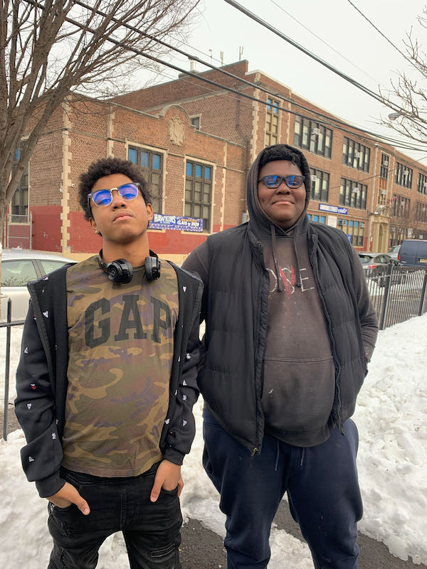 Michael Luna (Grade 7) and Troy Lee (Grade 8) are seen showing off their new blue light blocking glasses during the EyeBuyDirect distribution event!
