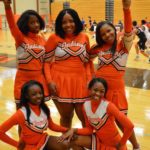 Cheerleaders stopped to take a quick pic during a home varsity basketball game
