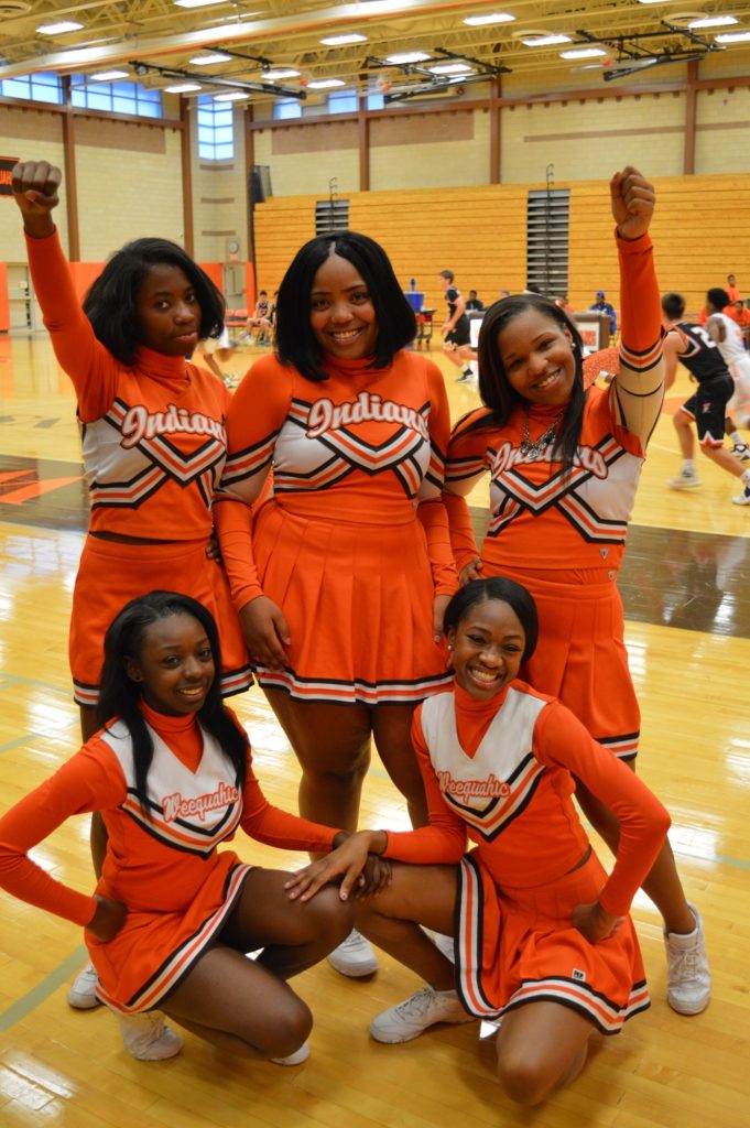 Cheerleaders stopped to take a quick pic during a home varsity basketball g...
