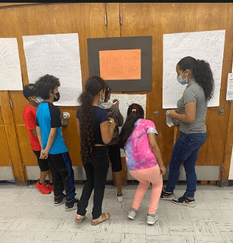 Summer students at McKinley Elementary School using the The Four Corners Strategy, an approach that asks students to make a decision about a problem or question.