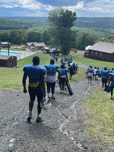 The Blue Devils of Central High School take in the scenic view at Camp Tioga while trekking their gear to football practice.