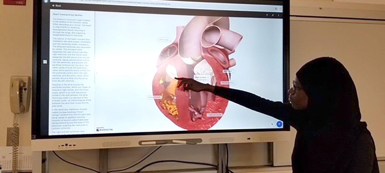 Student at Science Park High School interacting with a newly installed Smart Board