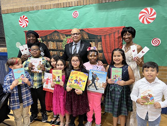 Hawkins Street School celebrates <em>The Book Lovers' Ball</em>, along with  Karen Leach-Toomer, Director of My Very Own Library, Principal Alejandro Lopez, and School Librarian, Ms. Jones