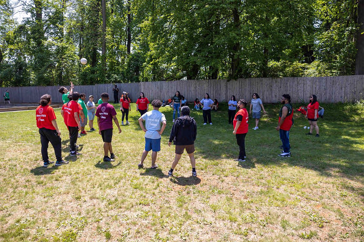 NPS high school students playing a game of Volleyball