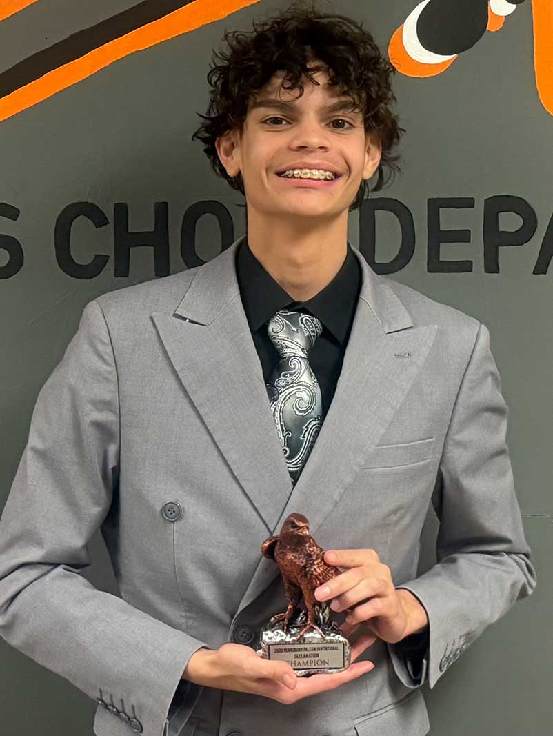 Josmanuel DeLeon holding his first place award for the Declamation category.