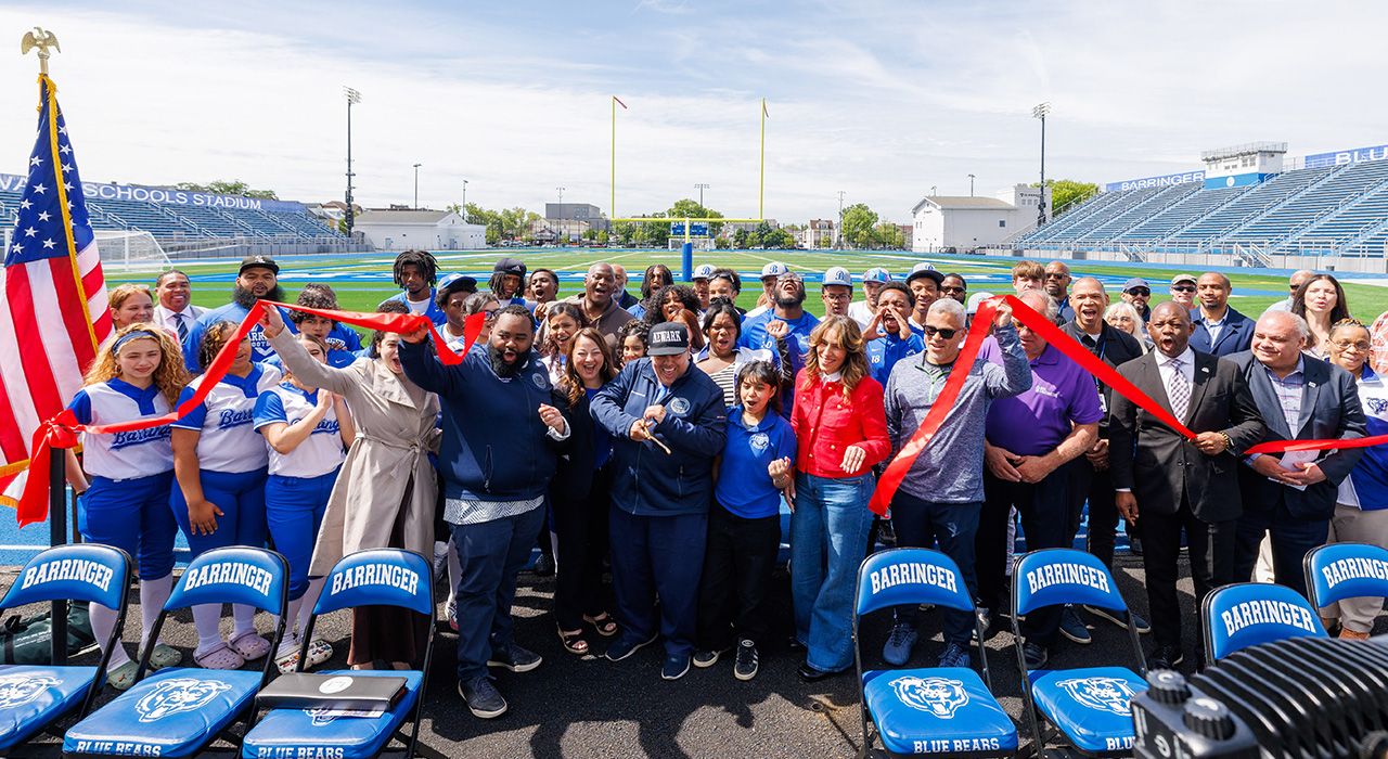 The gathering of Barringer High School students, teachers, administrators, Newark Public Schools leaders, and local elected officials cheer for the ribbon cutting of the newly renovated Newark Schools Stadium.