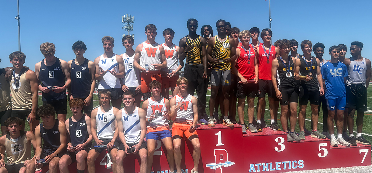 The Malcolm X Shabazz High School’s boys track relay team on the highest tier of the victory stand after winning the 4x800-meter relay championship.