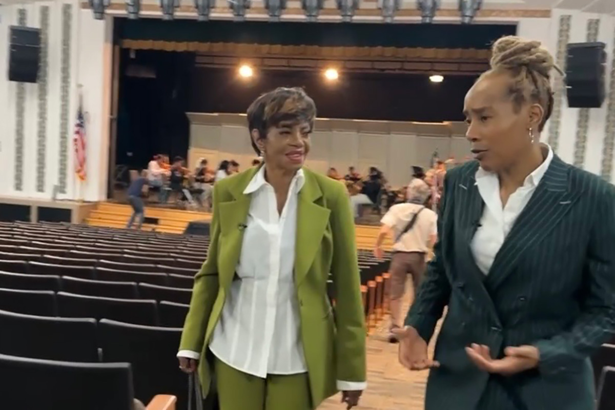 Melba Moore and Principal Regina Sharpe leave Arts High School auditorium after listening to the orchestra rehearse. Moore was a member of the orchestra as a student. 