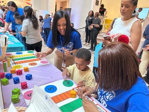 Quitman Street School teachers cheer on a student playing a math game.