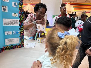 A teacher leads a literacy game with students. 