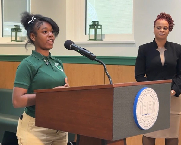 Nakira Poole speaks at the press conference for the official opening of the 403 Salon & Spa. In the background is teacher Nicole Daniels.